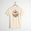 Hope Anchor Floral Shirt with a Hawaiian flowers print design displayed on a hanger against a white vertical panel background by Be Still and Know.