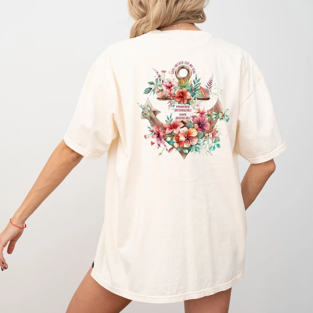 A person standing with their back to the camera, wearing a white t-shirt with a "Hope Anchor Floral Shirt" design by Be Still and Know.