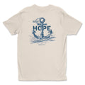 A beige Hope Anchors shirt from Be Still and Know with a graphic of an astronaut rising from ocean waves, surrounded by the word 