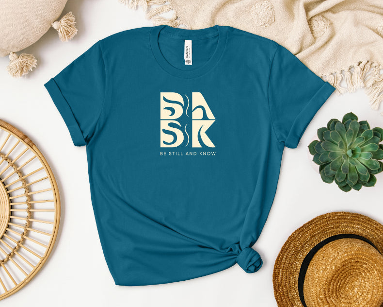 A Blessed Beginnings In Deep Teal t-shirt with the Be Still and Know logo.