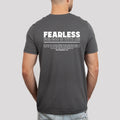 Man from behind wearing a Be Still and Know Fearless Shirt, gray with the text 
