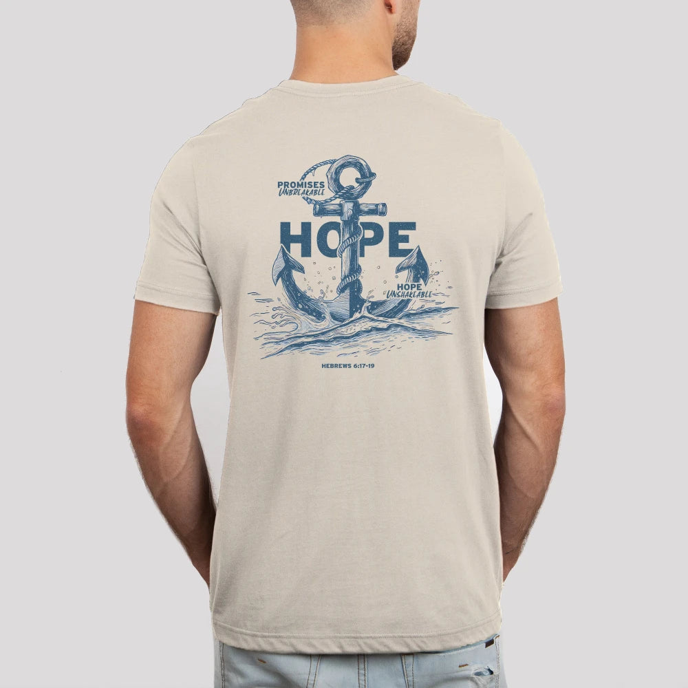 Man wearing beige t-shirt with nautical "Be Still and Know" Hope Anchors Shirt on the back, symbolizing unshakeable hope.