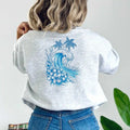 The back of a woman wearing a Kupa'a Tide Sweatshirt by Be Still and Know, showcasing Christian Apparel.