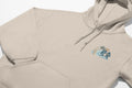 A beige Nalu o ka Mana (Waves of Faith) Hoodie with Christian imagery of a surfboard on it from Be Still and Know.