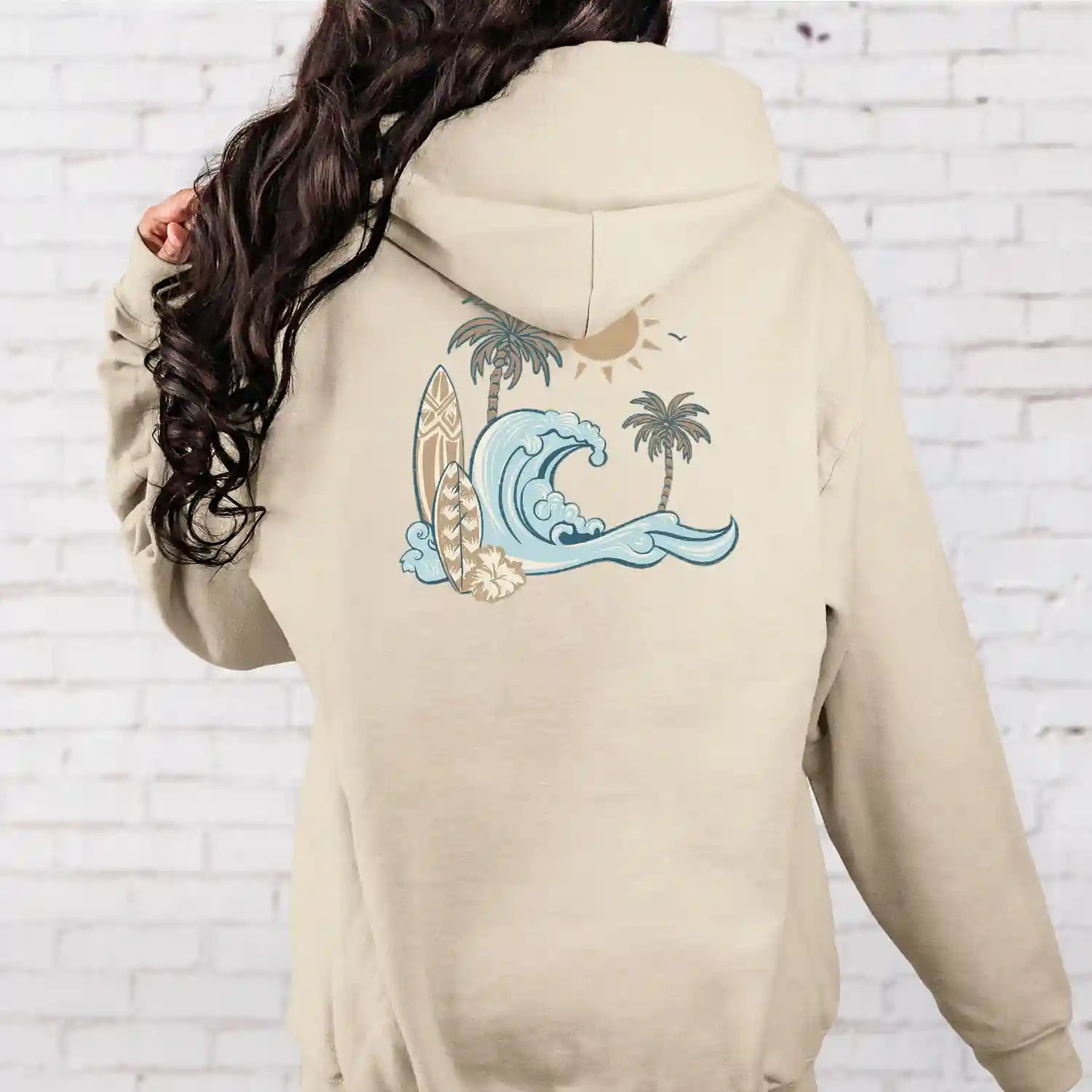 The back of a woman wearing a Nalu o ka Mana (Waves of Faith) Hoodie by Be Still and Know featuring the BSAK logo.