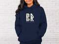 A woman wearing a navy hoodie with the words 