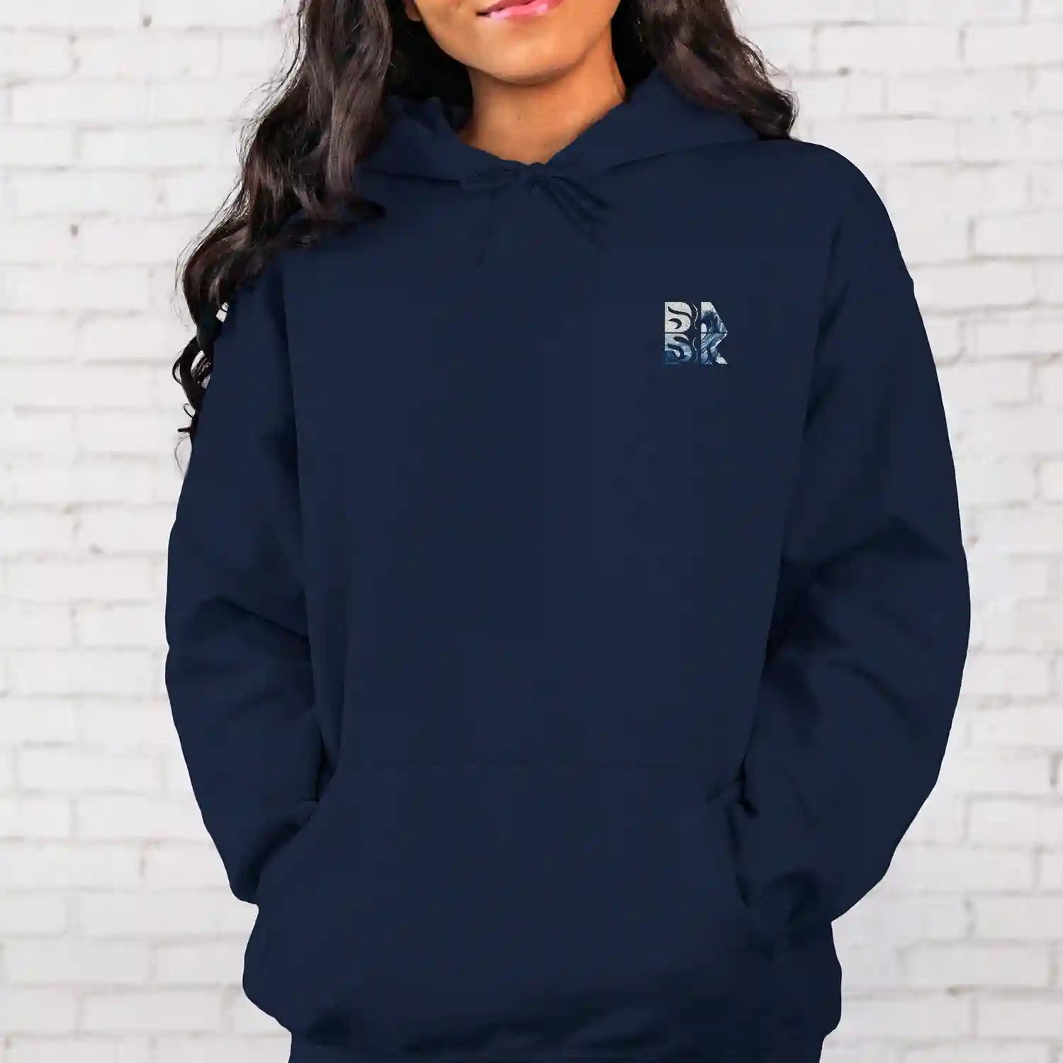 A woman wearing a navy Peace Be Still Hoodie with the letter r on it, showcasing Be Still and Know Christian Apparel.
