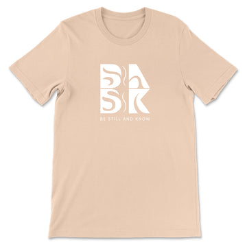 A Coastal Calm Tee In Sand Dune featuring the Be Still and Know logo, perfect for those looking for Christian clothing.
