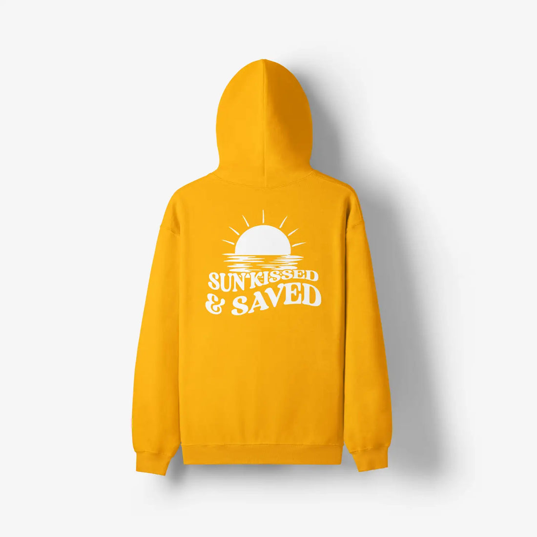 A woman wearing a yellow Sunkissed & Saved Hoodie by Be Still and Know, with the sun raised and saved faithfully printed on it.
