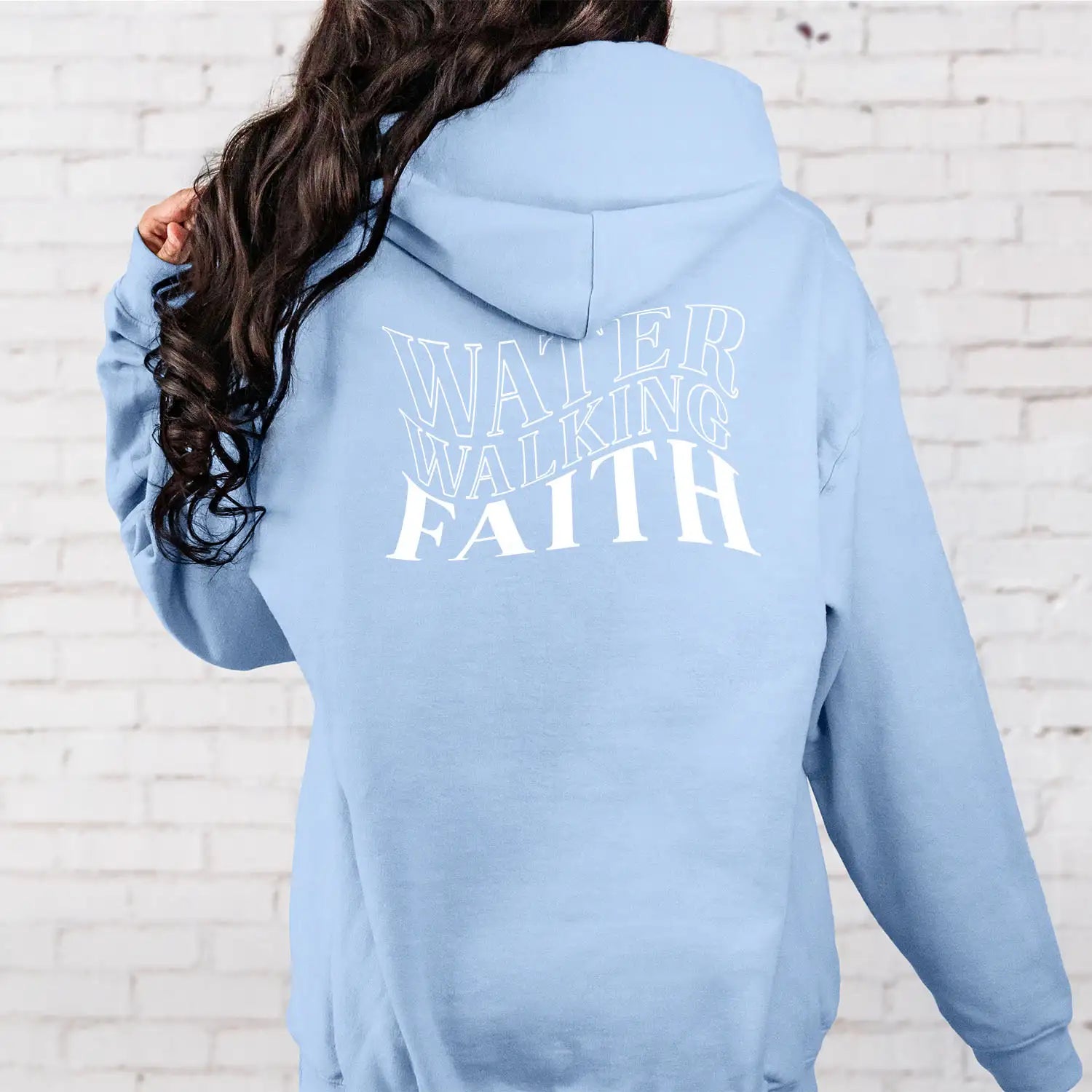 A person demonstrating their faith by wearing a Be Still and Know Water Walking Faith Hoodie.
